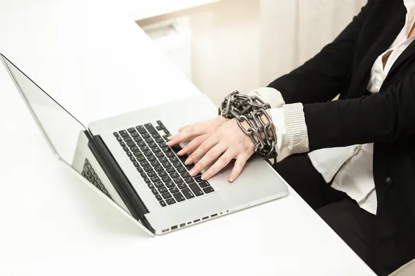 Chained businesswoman typing on keyboard — Stock Photo, Image