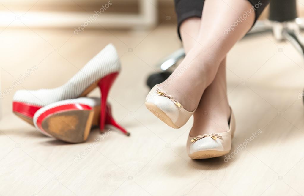 photo of woman wearing ballet flats instead of high heels