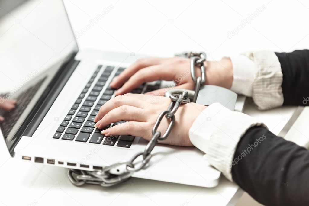 female locked to laptop by chain 