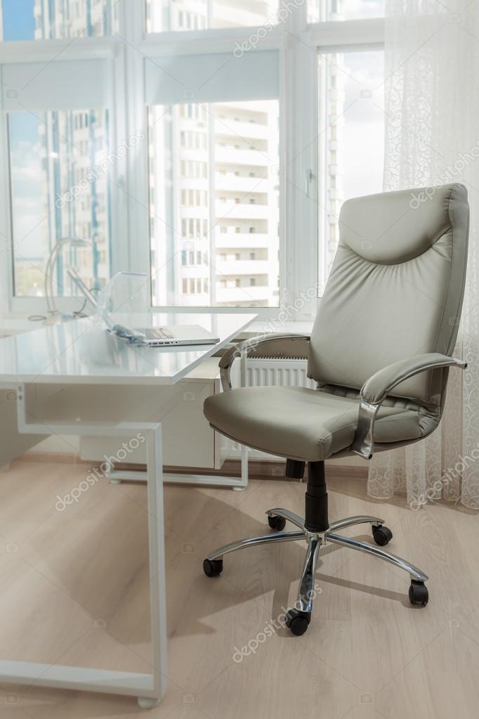 photo of office leather chair behind white working table