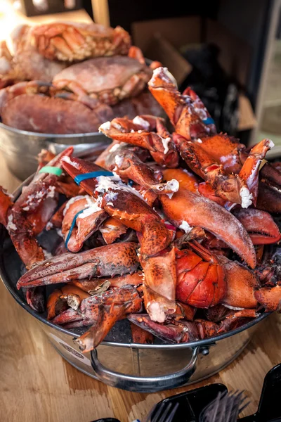 Lobster claws at metal bucket at kitchen — Stock Photo, Image