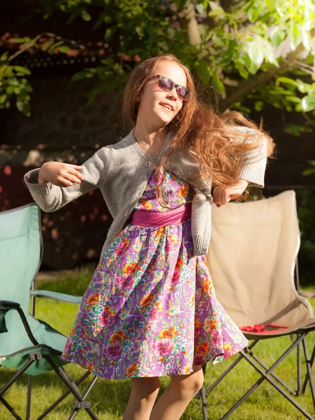 Smiling girl in cute dress dancing outdoor — Stock Photo, Image