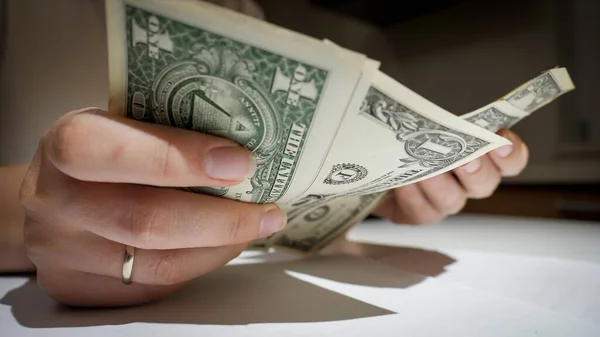 Closeup of female hands counting few money at night. Concept of financial difficulties, poverty, bankruptcy, taxes and rent payment. — Stock Photo, Image