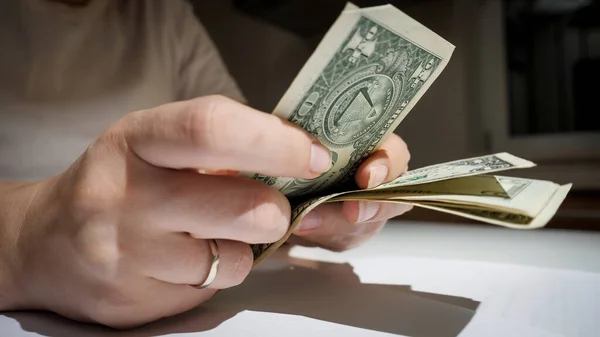 Closeup of woman counting and calculating US dollar banknotes in hands — Stock Photo, Image