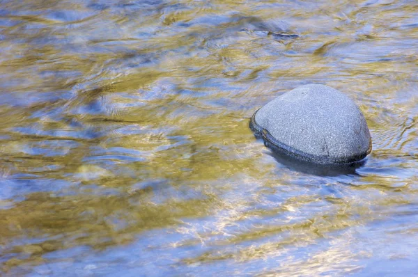 Solitary stone in a mountain river — Stock Photo, Image