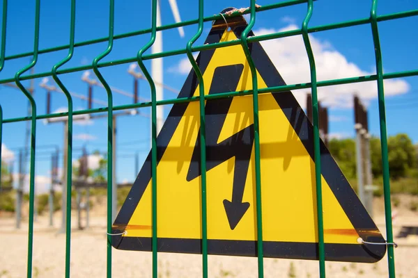 Electrical hazard sign placed on a metal fence.