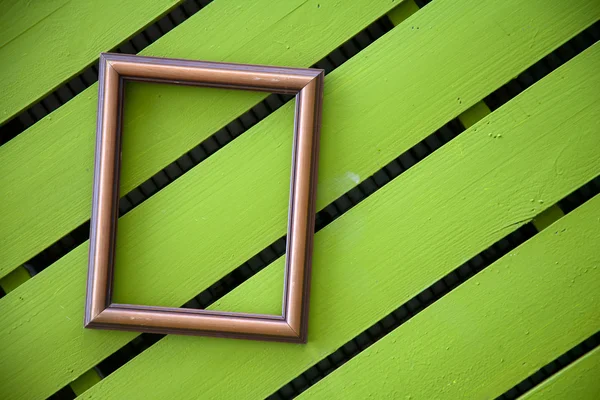 Photo frame on wood wall — Stock Photo, Image