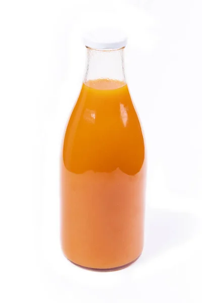 White Background Glass Bottle Orange Liquid Juice Tangerine Carrots Well — стоковое фото
