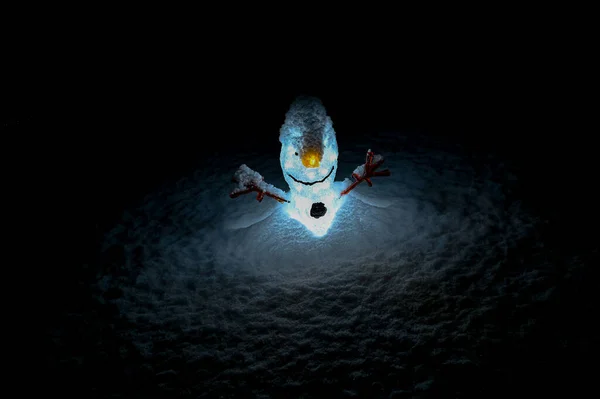 Small plastic snowman lamp standing outside in snow — Fotografia de Stock