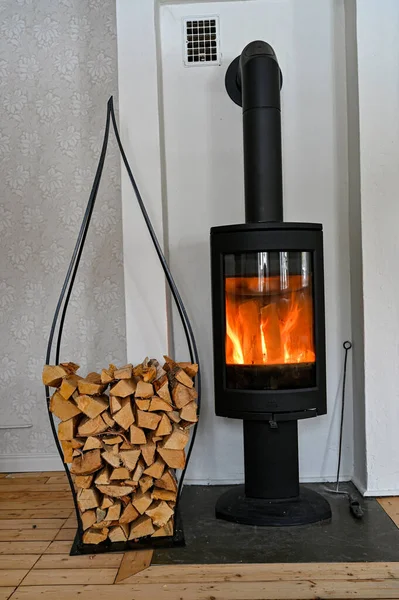 Pile of firewood and hot burning stove — Stok fotoğraf