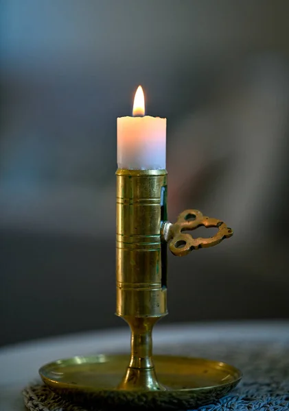 Close to small candle in candlestick made of brass — Photo