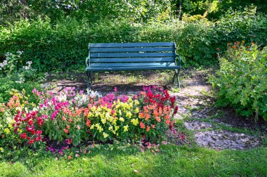green bench standing in a shaded area in garden Karlsund Garden Orebro Sweden august 4 2022
