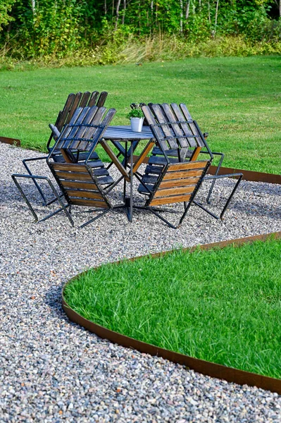 garden furniture with one table and four chairs on gravel