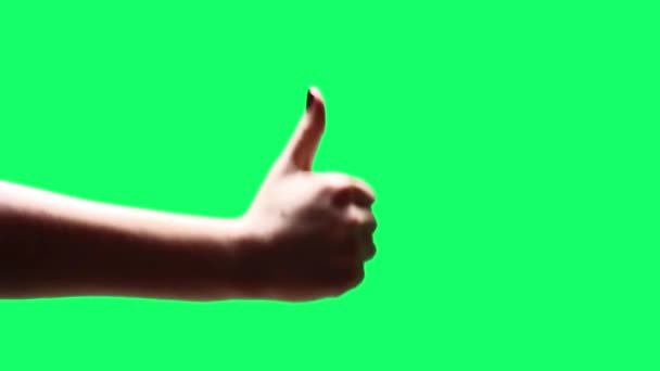 クロマの背景を上下に親指を示す女性の手 緑の画面を必要な映像や画像に置き換えることができます Effectsやその他のビデオ編集ソフトウェアでキーエフェクトを使用することができます チュートリアルを確認してください — ストック動画