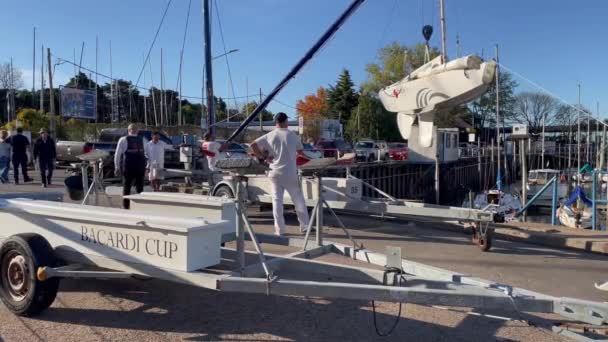 Groep Van Mannen Hijsen Zeilboot Met Behulp Van Een Kraan — Stockvideo