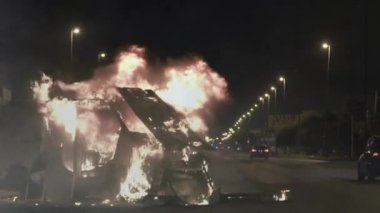 Burning Car on the Road in the Night. Zoom In. 