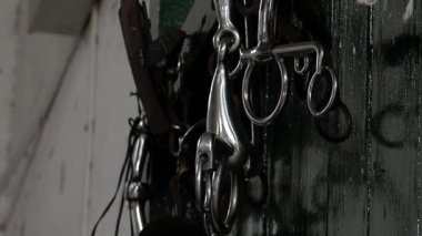 Traditional Gaucho Riding Gear used to Ride Horses Hanging from a Wall inside a Stable in Argentina. Close Up.  