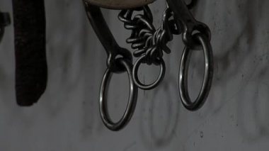Traditional Gaucho Riding Gear used to Ride Horses Hanging from a Wall inside a Stable in Argentina. Close Up. 