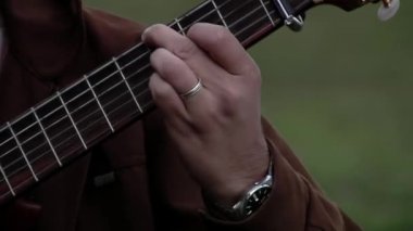 An Argentine Gaucho Playing Classical Guitar Outdoors. Close Up. 