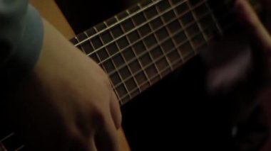 Young Man Practising Chords With Classical Guitar. Close Up. 