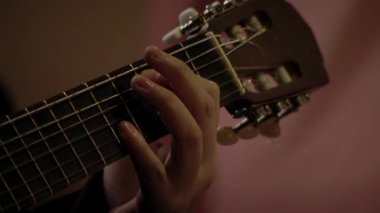 Young Man Practising Chords With Classical Guitar. Close Up.  