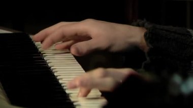 Hands of a Young Man Playing Piano. Close Up. 