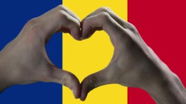Hands showing Heart Sign over Romania Flag. 