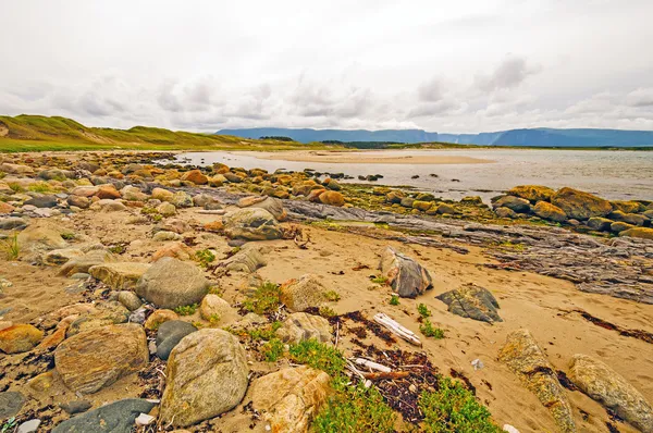 Sand och klippor där havet och floden möts — Stockfoto