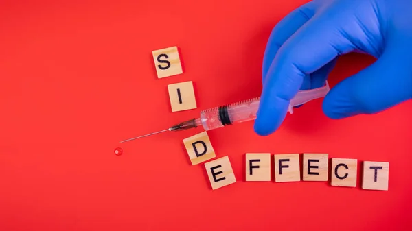 Syringe Filled Solution Words Side Effect Colored Red Paper Texture — Stock Photo, Image