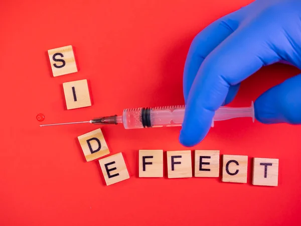 Syringe Filled Solution Words Side Effect Colored Red Paper Texture — Stock Photo, Image