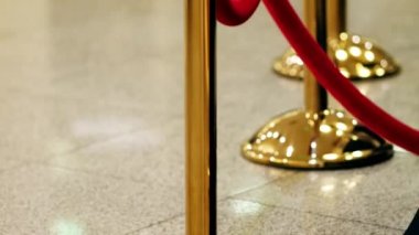 Velvet red luxury ropes closed at valuable exhibit in museum or vip zone concert