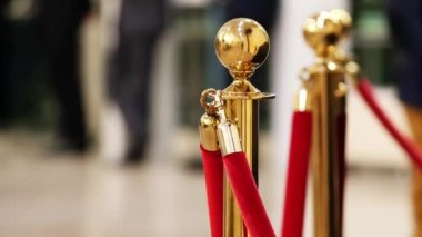 Velvet red luxury ropes closed at valuable exhibit in museum or vip zone concert