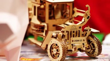 Plywood toy car. 3D model made of wood. Trendy woodcraft mechanisms. Laser cut