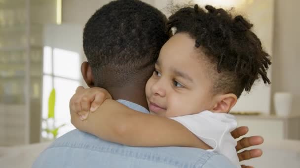 Happy 3 year old mixed race kid hugging black skin african american father. Happy hugs of family of father and son, friendship in family of child and dad. Relationships in family, love hugs. — Wideo stockowe