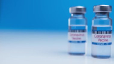 Many ampoules with COVID-19 coronavirus vaccine. Bottle of vaccine against SARS-CoV-2 virus on background laboratory table. Drugs against nCoV pandemic. Concept defeating coronavirus