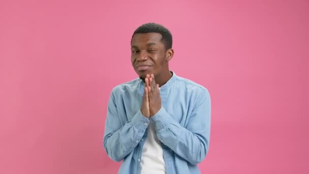 Black Man Asks Forgiveness Folding His Hands Together Pink Background — Videoclip de stoc