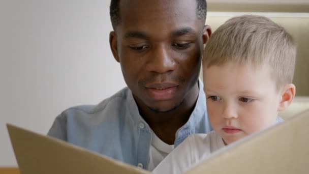 Portrait African American Father Reads Book His Adopted Child European — Stockvideo