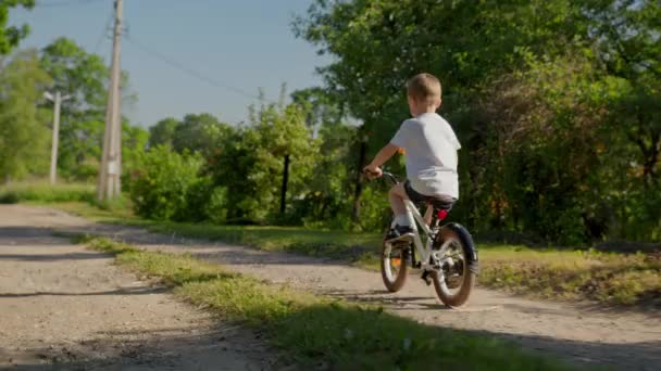 Child Riding Bicycle Dirt Road Country Village Summer Sunny Weather — Stockvideo