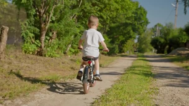 Child Riding Bicycle Dirt Road Country Village Summer Sunny Weather — Stockvideo