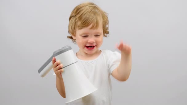 Happy Toddler Girl Plays White Megaphone Studio Child Smiles Waving — Wideo stockowe