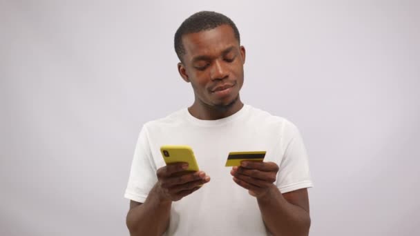 Cheerful African American Man Wearing White Shirt Making Payment Smartphone — Vídeos de Stock