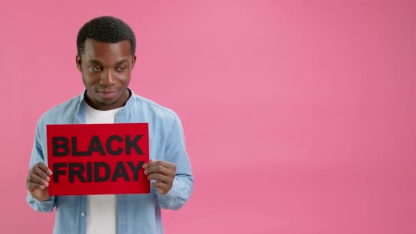 African American Denim Shirt Raises Banner Inscription Black Friday Rejoices — Stock video