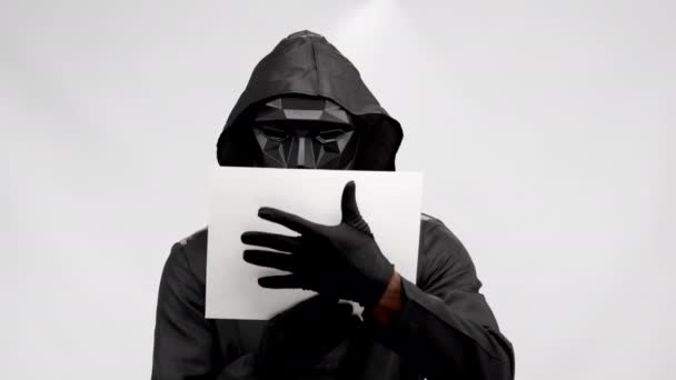 Man Black Suit Hood Black Mask Red Text Banner Black — Video Stock
