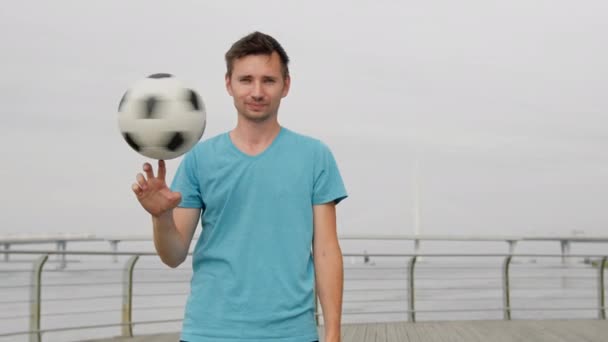 Man Professional Soccer Player Blue Shirt Spinning Ball His Finger — Stok Video
