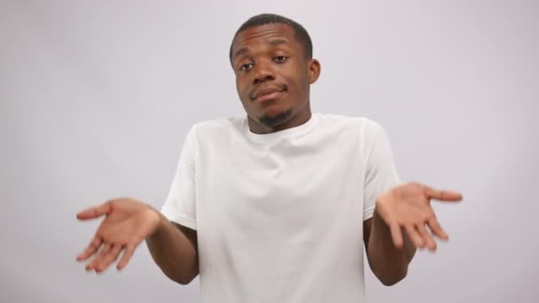 Confused African American Man White Shirt Shrugs Shoulders Bewilderment Doubtful — стокове відео