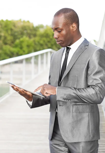 Businessman using electronic tablet — Stock Photo, Image