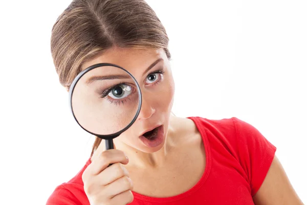 Amazed woman holding a magnifying glass — Stock Photo, Image