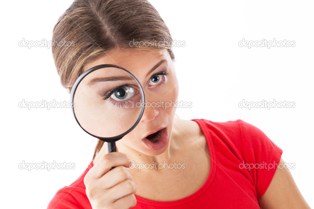 Amazed woman holding a magnifying glass