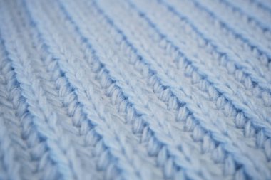 Örgü yün kumaşın ayrıntıları. Tekstil arka planı. Yünlü doku arka planı, örgü yün kumaş, tüylü yumuşacık tekstil. Yakın çekim.