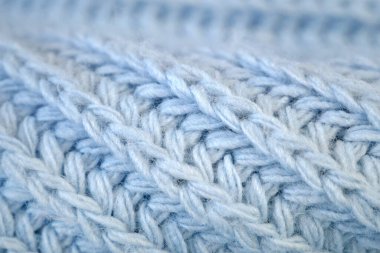 Örgü yün kumaşın ayrıntıları. Tekstil arka planı. Yünlü doku arka planı, örgü yün kumaş, tüylü yumuşacık tekstil. Yakın çekim.